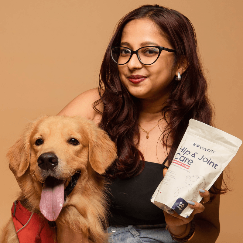 Pet parent with Golden Retriever and K9 Vitality supplement